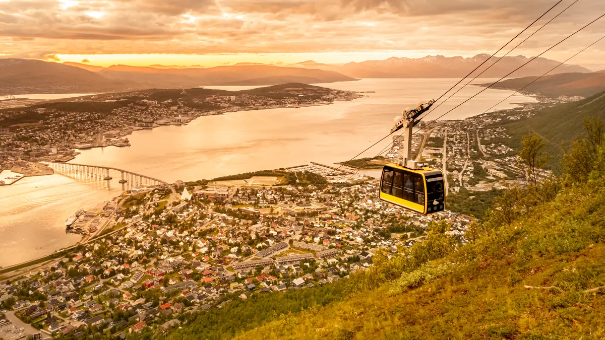 Cable car over Tromsø harbour and fjord during the midnight sun in summer