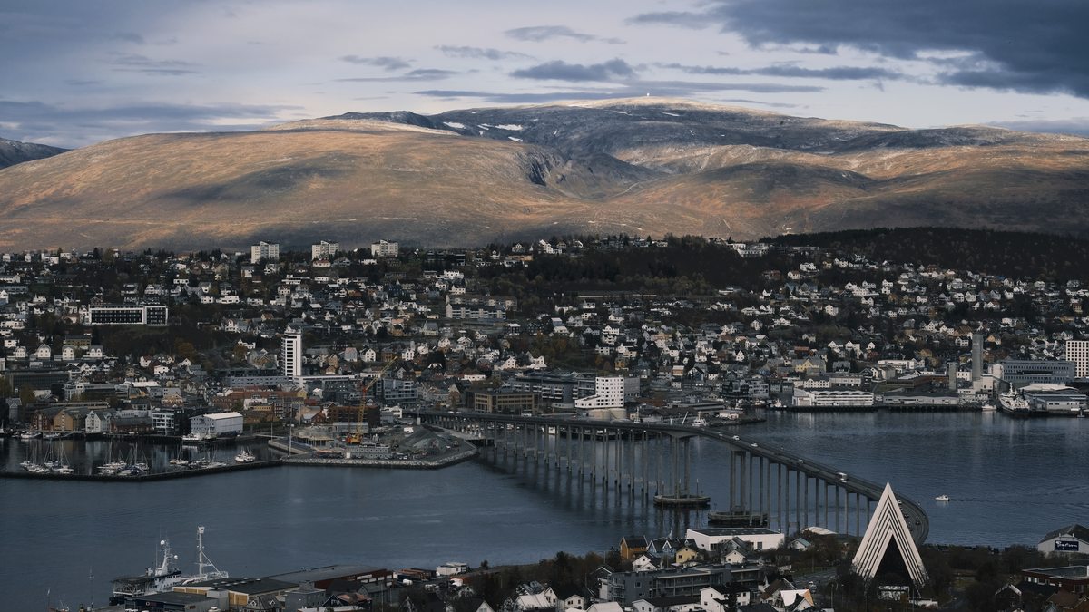 Autumn view over Tromsø with the bridge, Arctic Cathedral and snow-dusted mountains
