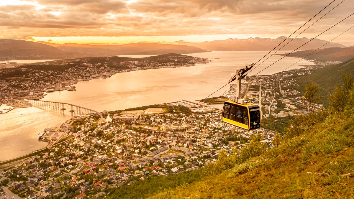 The Fjellheisen cable car above Tromsø and the fjord in low evening light