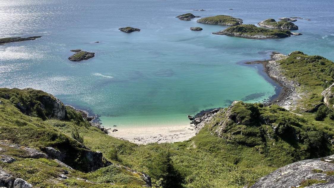 Turquoise water and a white-sand Arctic beach near Tromsø in summer